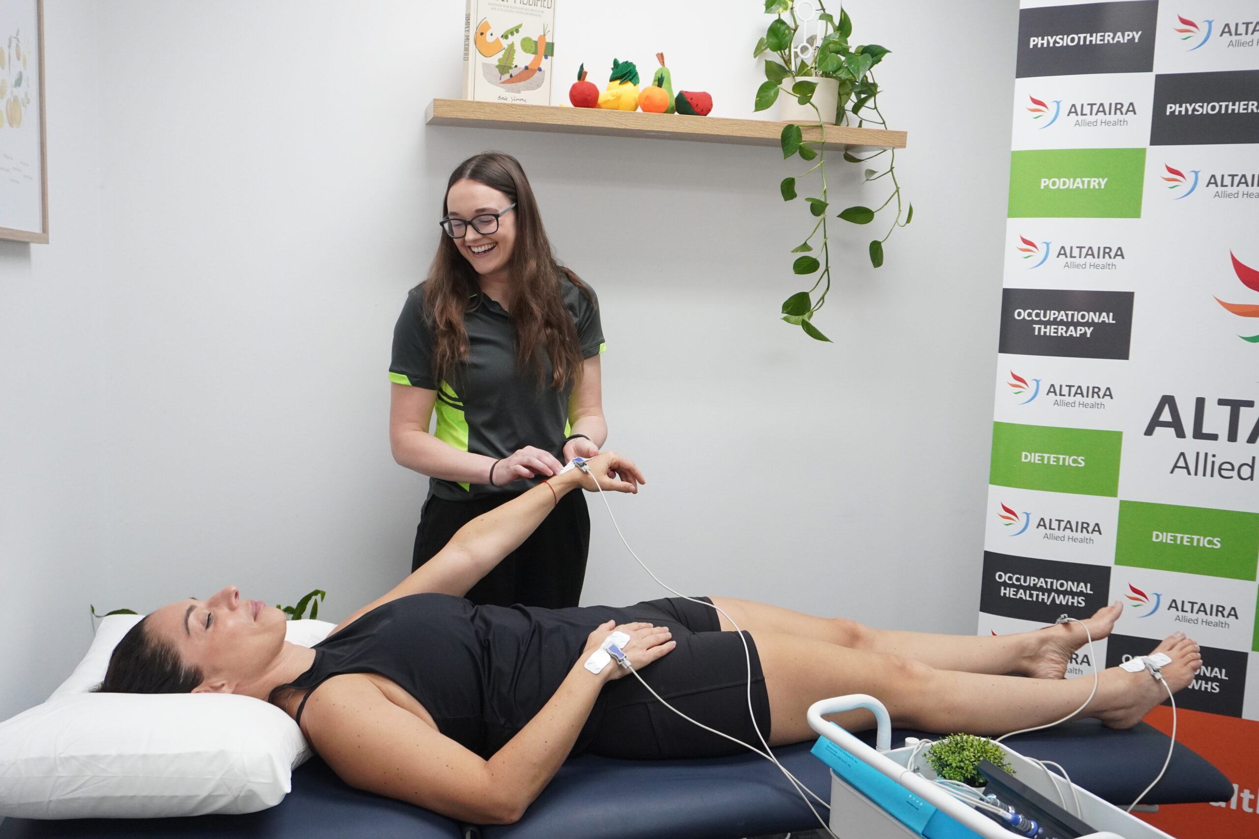 Clinician performing a BIA101 BIVA assessment with electrodes on the hand and foot