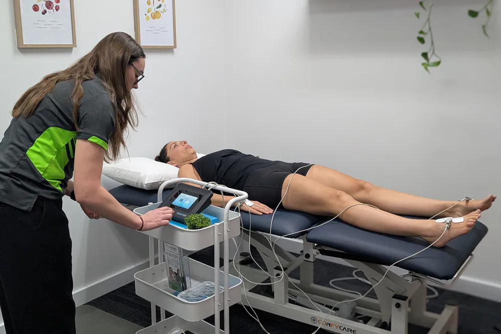 Clinician performing a BIA101 BIVA assessment with electrodes on the hand and foot