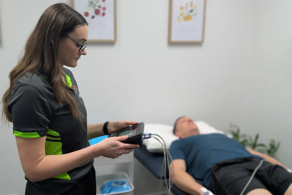 Dietitian reviewing bioelectrical impedance vector analysis results on the AKERN BIA101