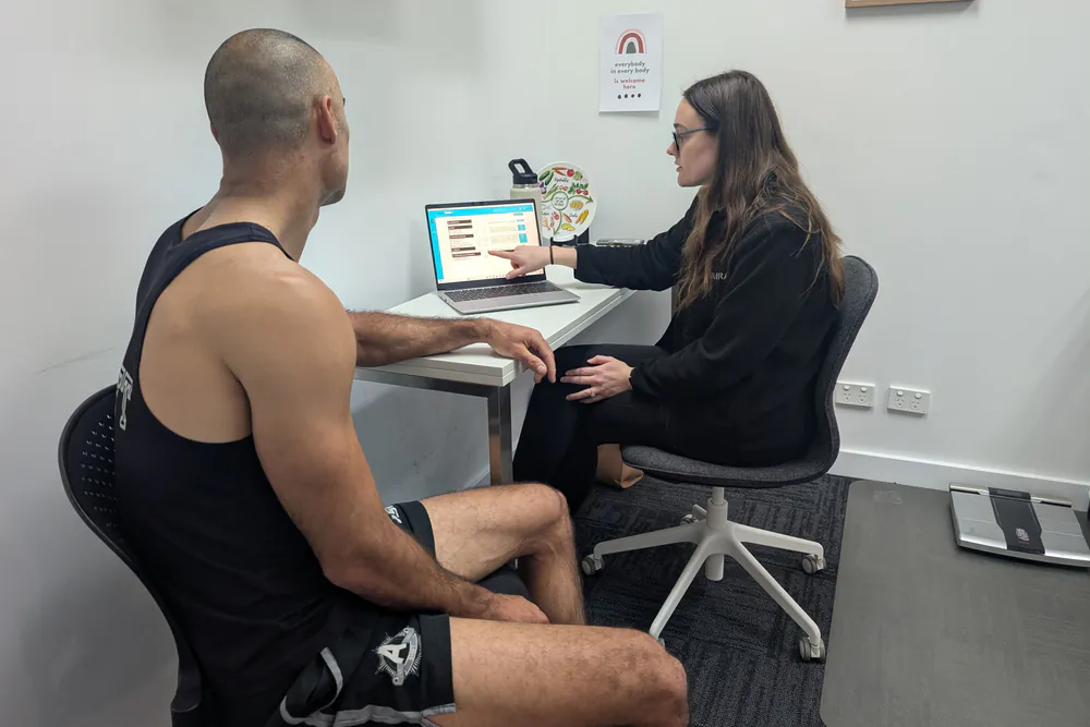Clinician reviewing strength assessment results with a client